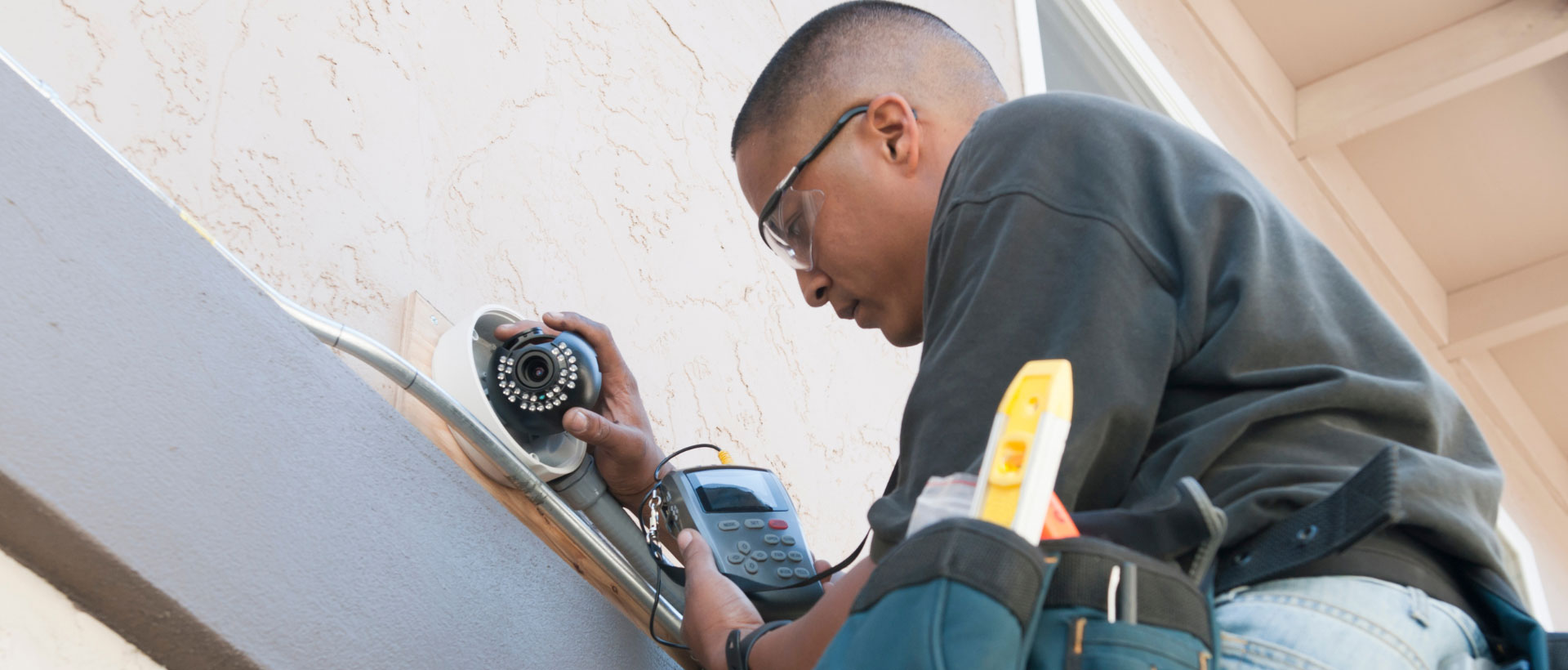 Young man installing Security Camera Systems